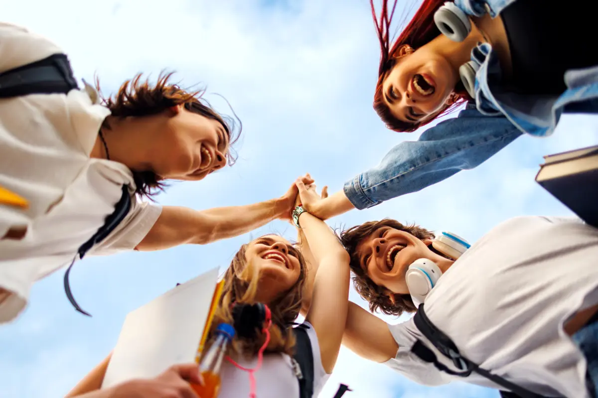 happy students joining hands celebrating success o 2026 01 09 10 43 32 utc