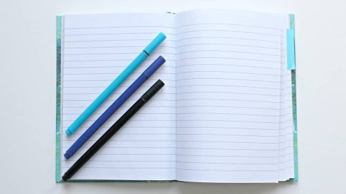 Pens over a notebook