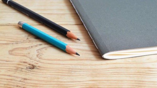 Pens next to a textbook