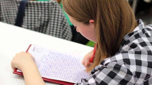 A girl writing on a piece of paper